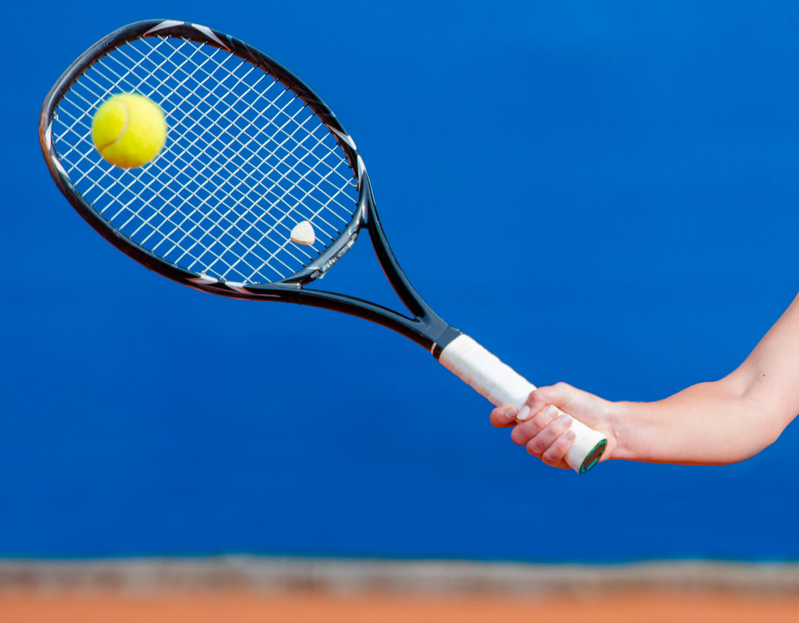 Close-Up of Hand Gripping Racquet